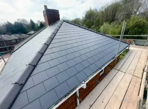 Newly tiled hipped grey slate roof